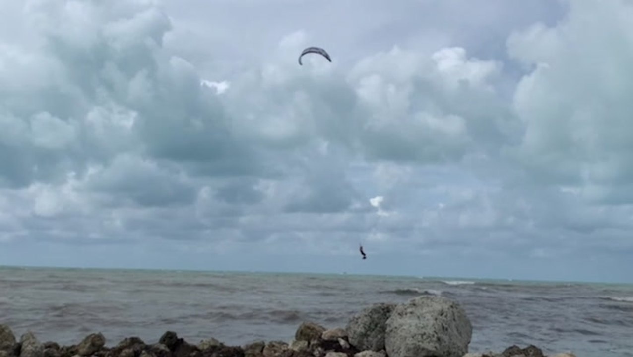 One brave soul kite surfs on Fred-churned waters