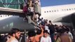 Desperate Afghans clamber onto plane to flee country after Taliban victory