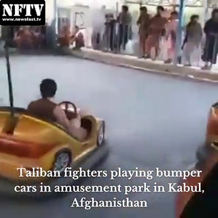 Taliban fighters playing bumper cars in an amusement park in Kabul