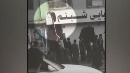 Salon staff paints sign boards black as Taliban takes over Afghanistan