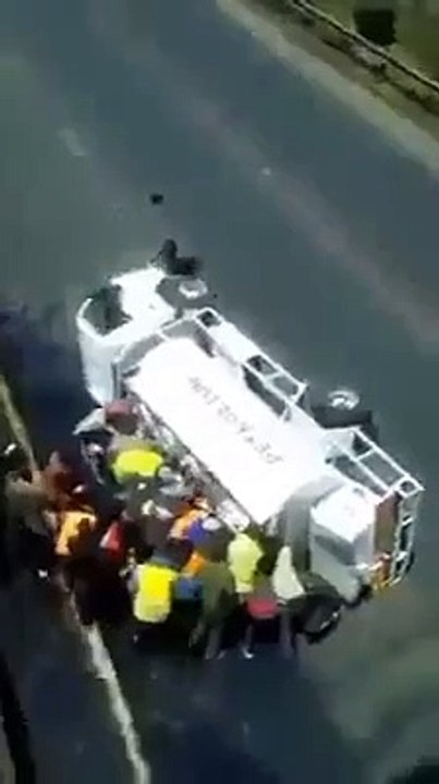 Kenyans siphon fuel from a petrol truck that had an accident