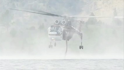Firefighting helicopter refills from a California lake