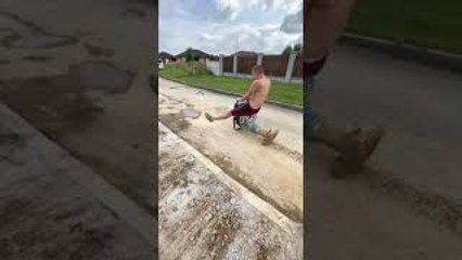 Construction Worker Takes Asphalt Compactor for a Drive