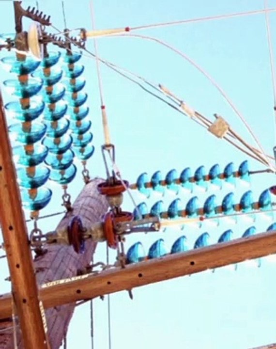 Various arrangements of insulators on transmission towers.
