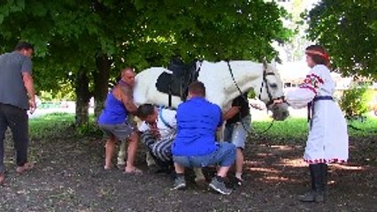 Strong Man Walks Carrying a Horse
