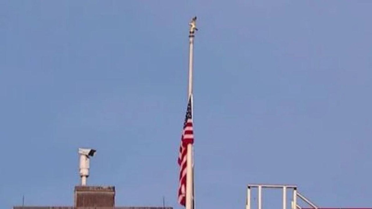 US national flag bowed in honor of soldiers killed in Kabul