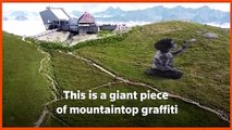 Graffiti artist creates giant mountaintop artwork