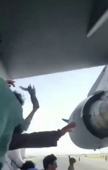 The plane is about to take off. Afghan citizens lay on the plane. Scary scene