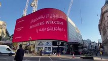 Afghan refugees are welcomed to London with a sign up in Picadilly Circus