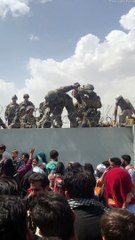 Afghan Infant Passed to Soldiers at Airport