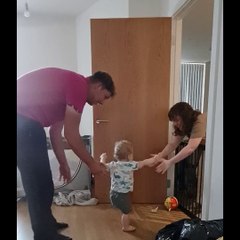 Excited Parents Encourage Son's First Steps
