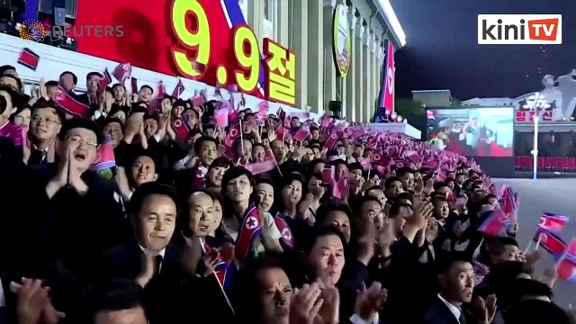 N. Korea puts hazmat suits on parade for national day, but no missiles