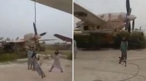 Taliban fighters Swings on US dismantled aircraft