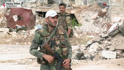 Syria regime and Russian flags fly in destroyed Daraa after truce deal