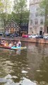 Guy Pushes Raft of People Down Canal