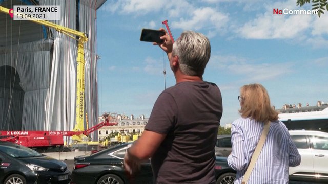 Parisians, tourists admire wrapping of Arc de Triomphe, tribute to Christo