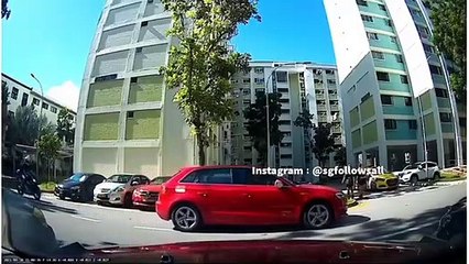 Reckless Red car reverses without due car and almost runs down a motorcyclist who was stationed behind him