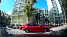 Reckless Red car reverses without due car and almost runs down a motorcyclist who was stationed behind him