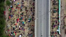 Drone video shows migrants under Texas bridge