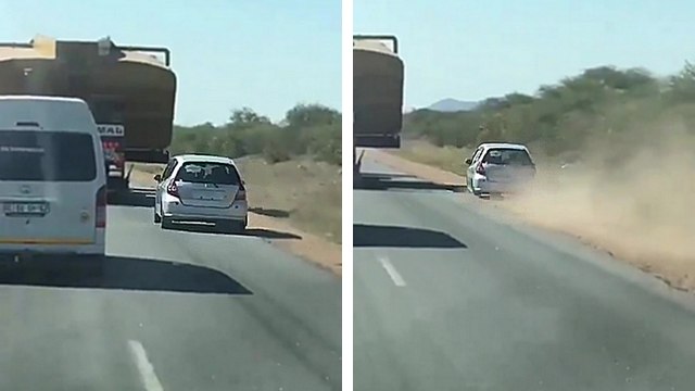 Un automobiliste tente de doubler un camion en passant par le bas-côté