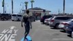 Guy Displays a Handstand While Skating In Surfboard Shaped Skateboard On the Streets