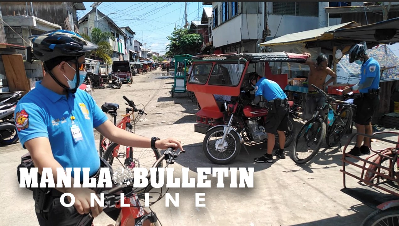 Cops on bikes issue tickets to erring residents for not wearing facemask in Isla Verde in Davao City