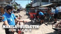 Cops on bikes issue tickets to erring residents for not wearing facemask in Isla Verde in Davao City