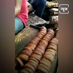 Workers in a Biscuit Making Unit Licking Toasts Before Packing.