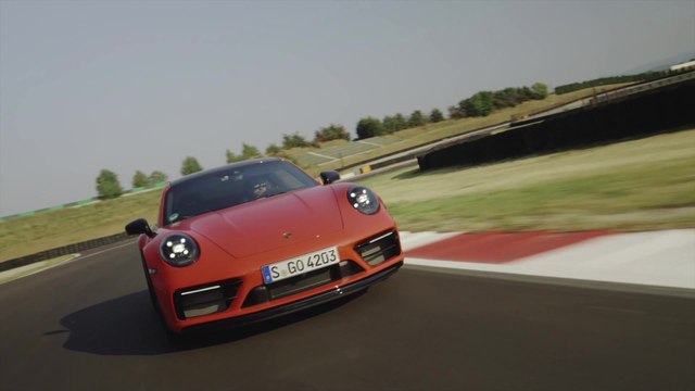 Porsche 911 Carrera 4 GTS Coupe in Lava Orange Driving Preview
