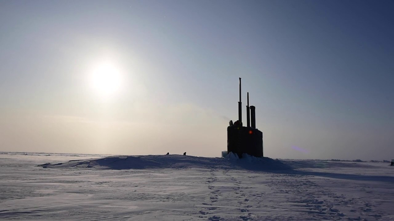 US Navy Submarine Surfaces through the Ice during Ice Exercise