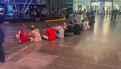 City Walk onlookers watch the opening ceremony on the big screen