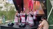 Performers sing traditional songs outside the Belarus pavilion