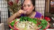 Asian mama eating Thai food with delicious vegetable