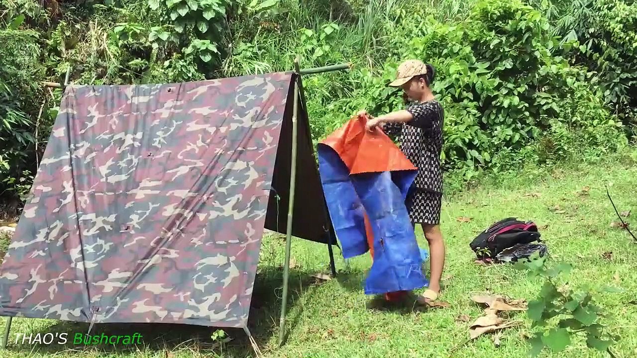 Bushcraft Camping - The girl in the Bushcraft summer camp cooks and cools off alone in the forest