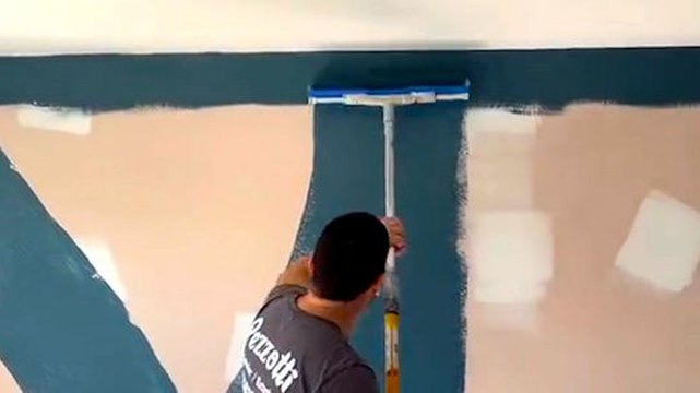 Professional painter shows the fastest way to paint a wall