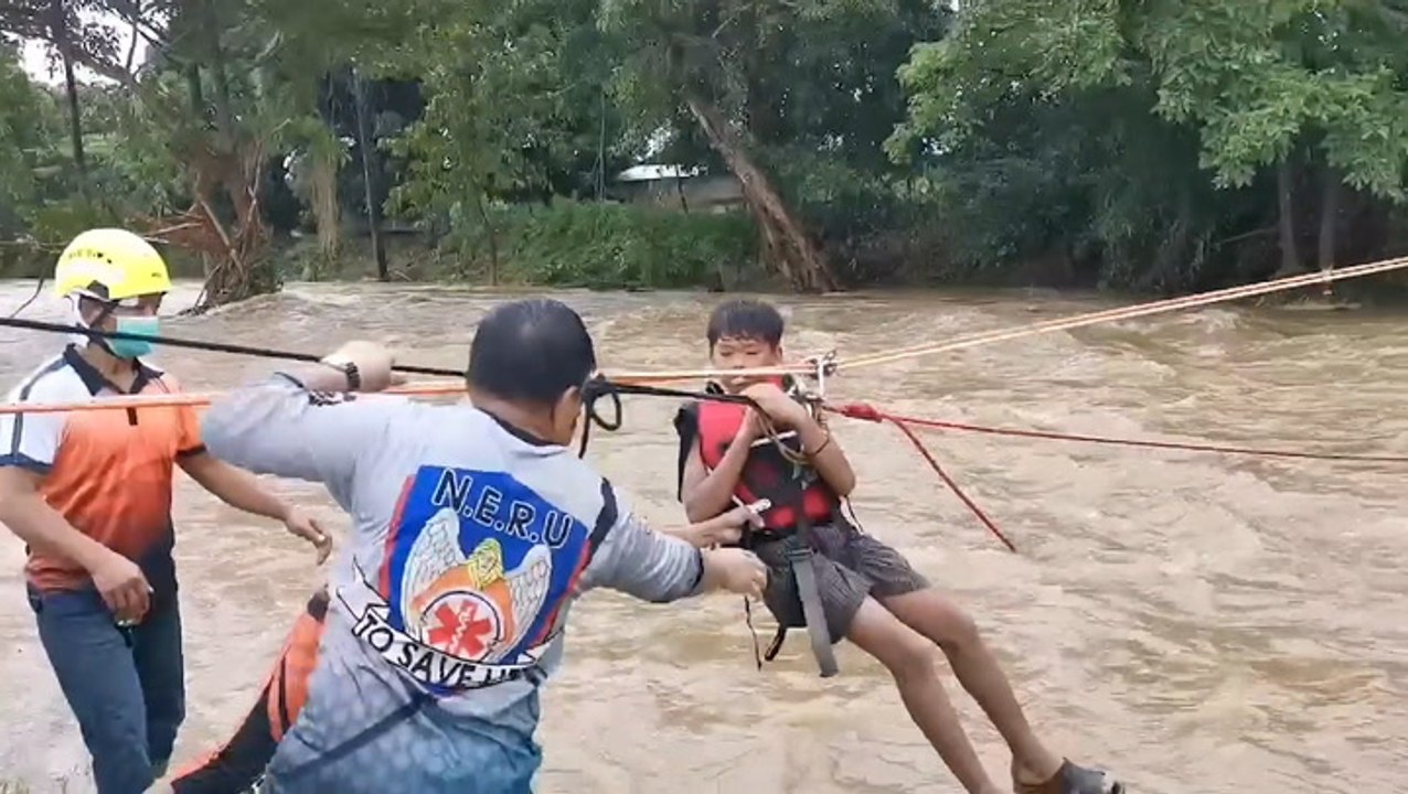 Dramatic zipline rescues over flooded river
