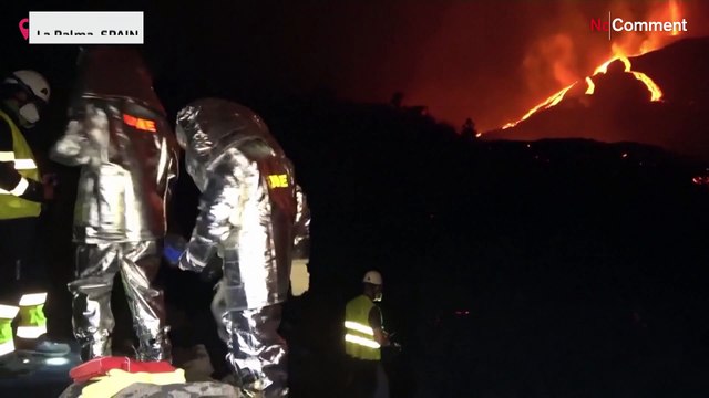 Members of Spanish military monitor lava temperature on slopes of La Palma volcano.