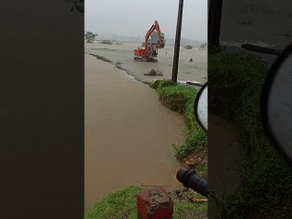 Excavator Returning to Shore Wades Against Floodwaters