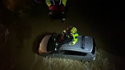 Firefighters Rescue Man Trapped in Car During Flood