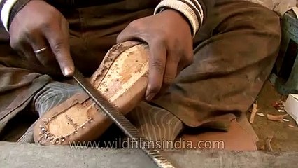 Cobbler making leather boots by hand