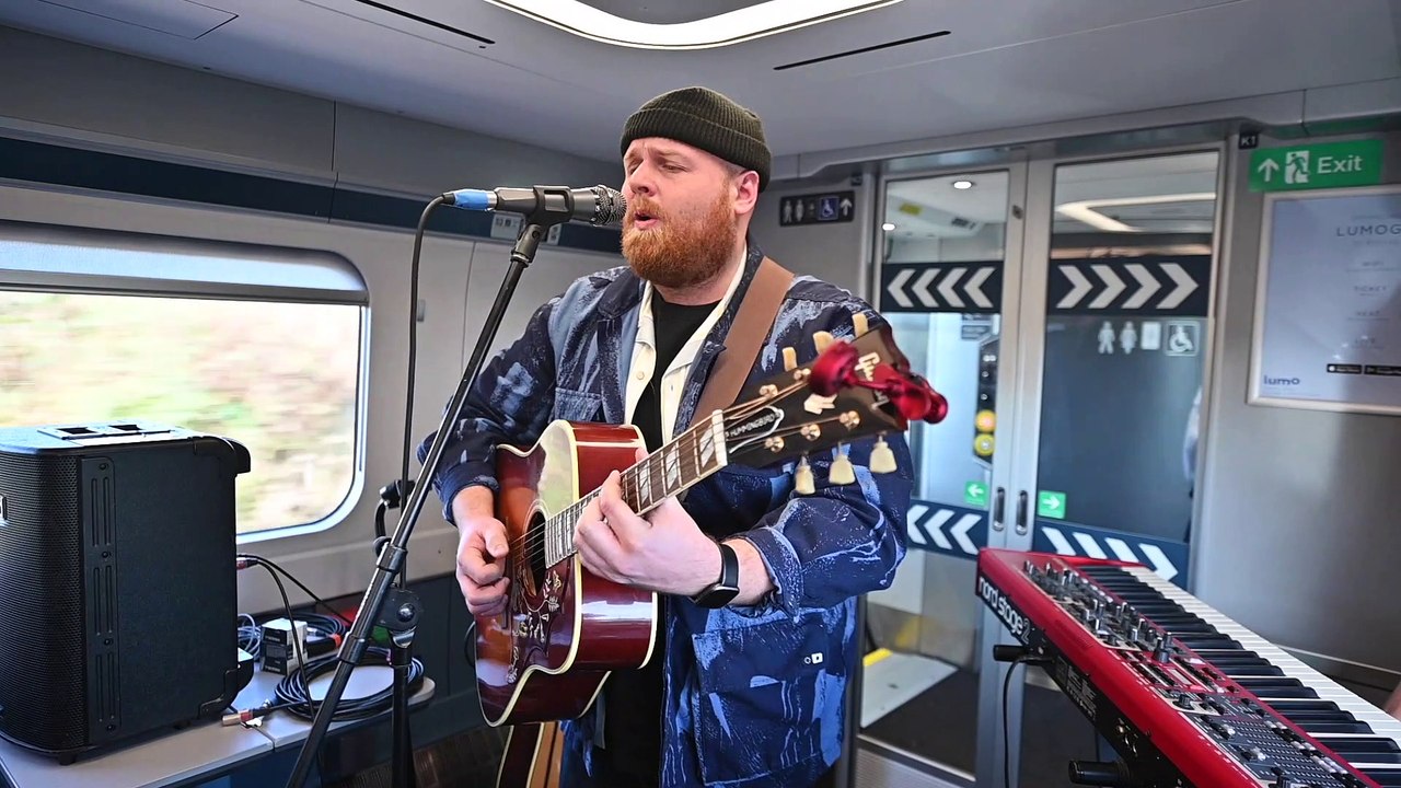 Tom Walker sings on a train
