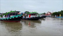 5 Tugboats pulling a  barge of Koh Kret at Chao Phraya river in Thailand