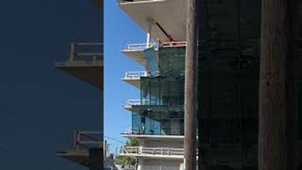 Construction Workers Break Large Glass Window