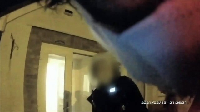 Chilling footage shows the moment a woman was arrested while refusing to help her 'abusive' husband as he lay dying on the kitchen floor