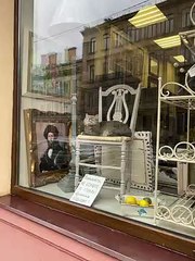 Cat Relaxes In Antique Store Window