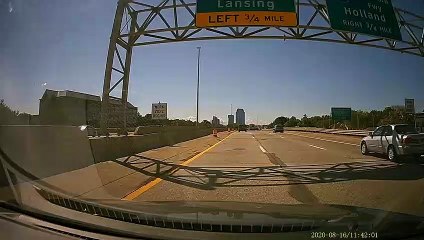 Car Slides Into Center Barrier at High Speed