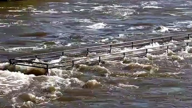 Swollen river spills over and floods in New York