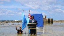 Tuvalu minister stands in sea to deliver COP26 speech and show climate change