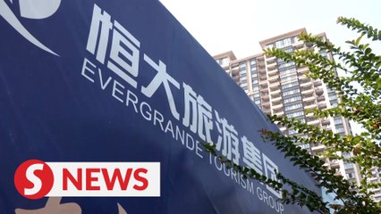 Evergrande dodges default, again
