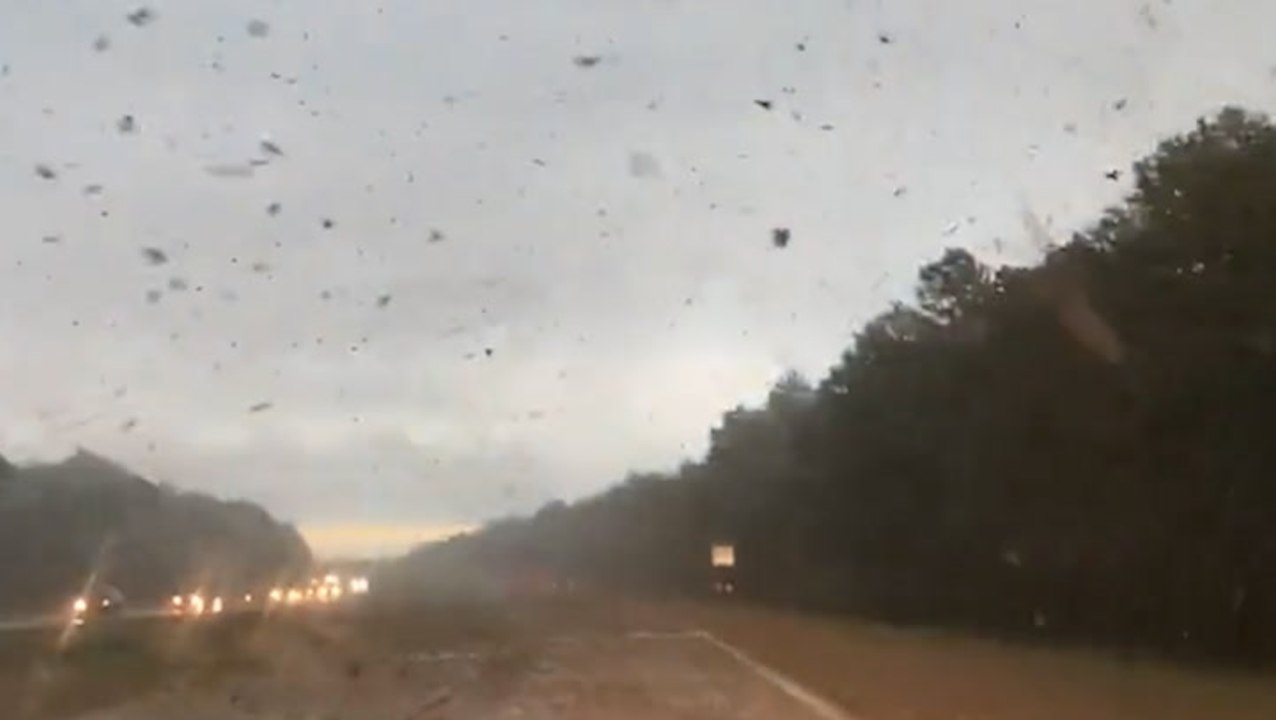 Debris flies across road amid tornado in Long Island